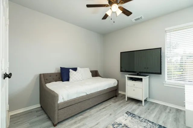 a bedroom with a bed and a flat screen tv