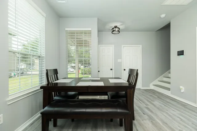 a view of a dining room with furniture and wooden floor