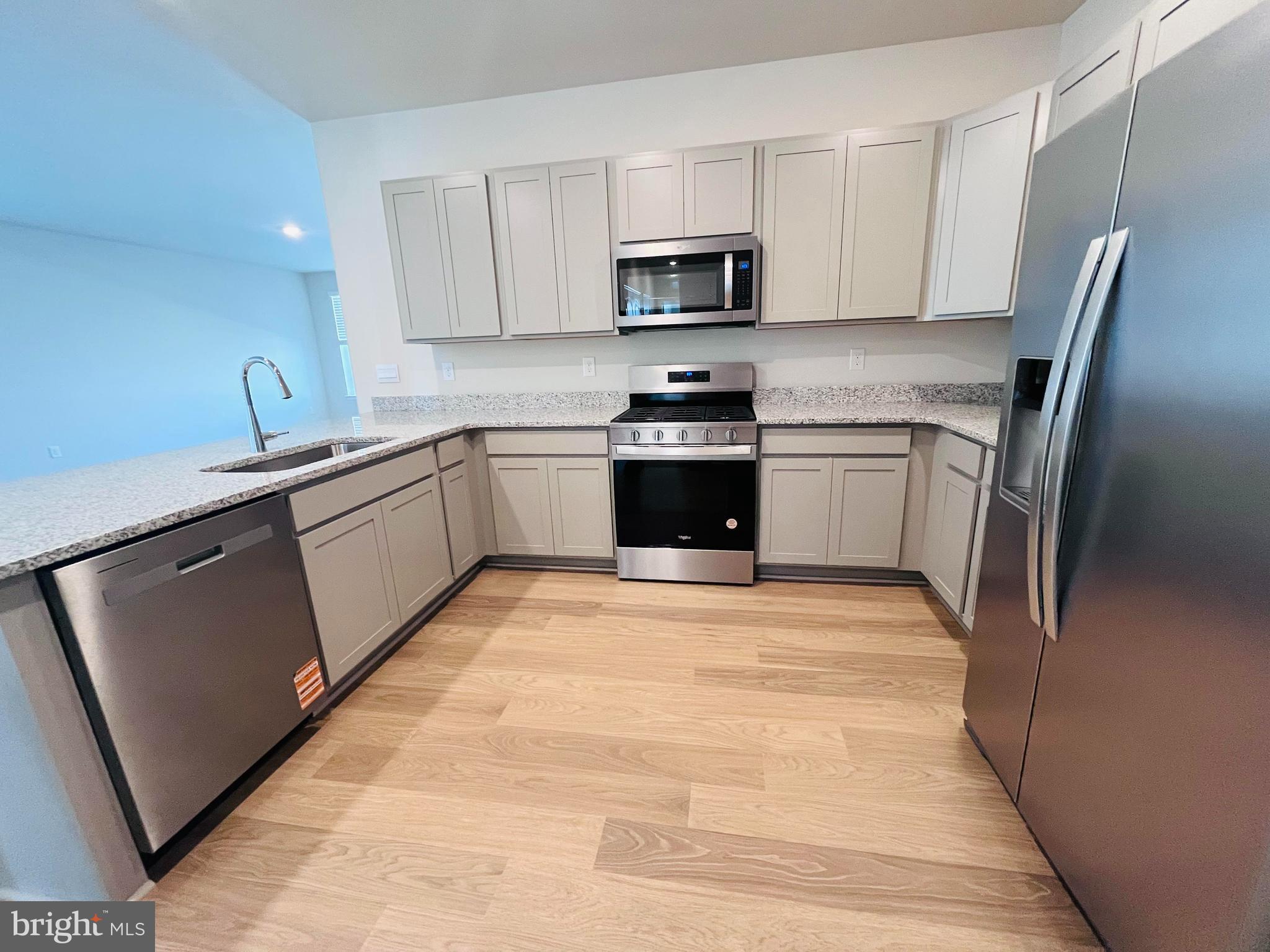 120 Ridgley Boulevard Dover, DE 19904 - Photo 6 of 17 a kitchen with stainless steel appliances granite countertop a refrigerator sink and stove
