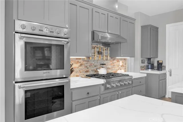 a kitchen with a refrigerator sink and cabinets