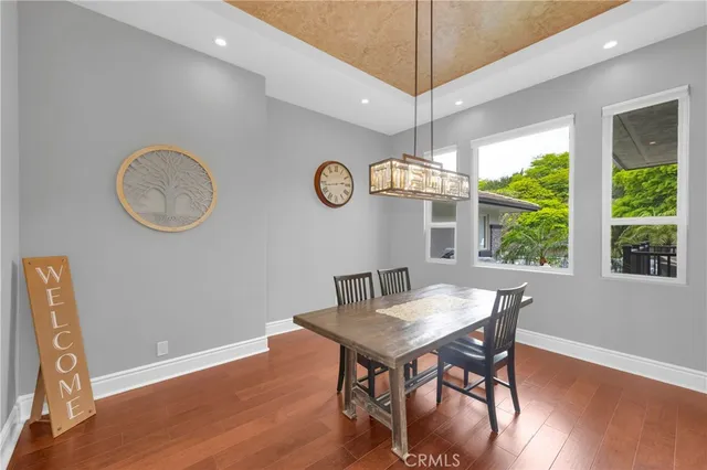 a bedroom with a bed and a flat tv screen on dresser