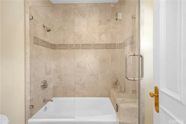 a bedroom with a bed and a television