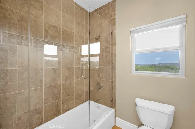 a bathroom with a granite countertop sink a toilet and a mirror