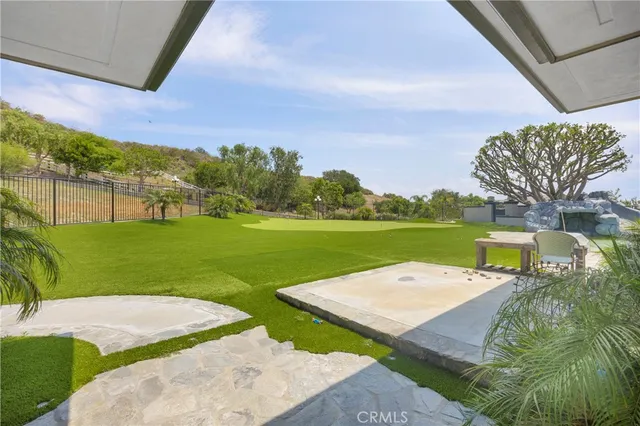 a large room with kitchen island granite countertop lots of wooden cabinets