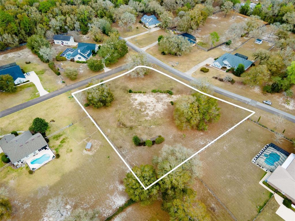 9050 Southwest 84th Street Gainesville, FL 32608 - Photo 19 of 20 a view of a swimming pool with a yard