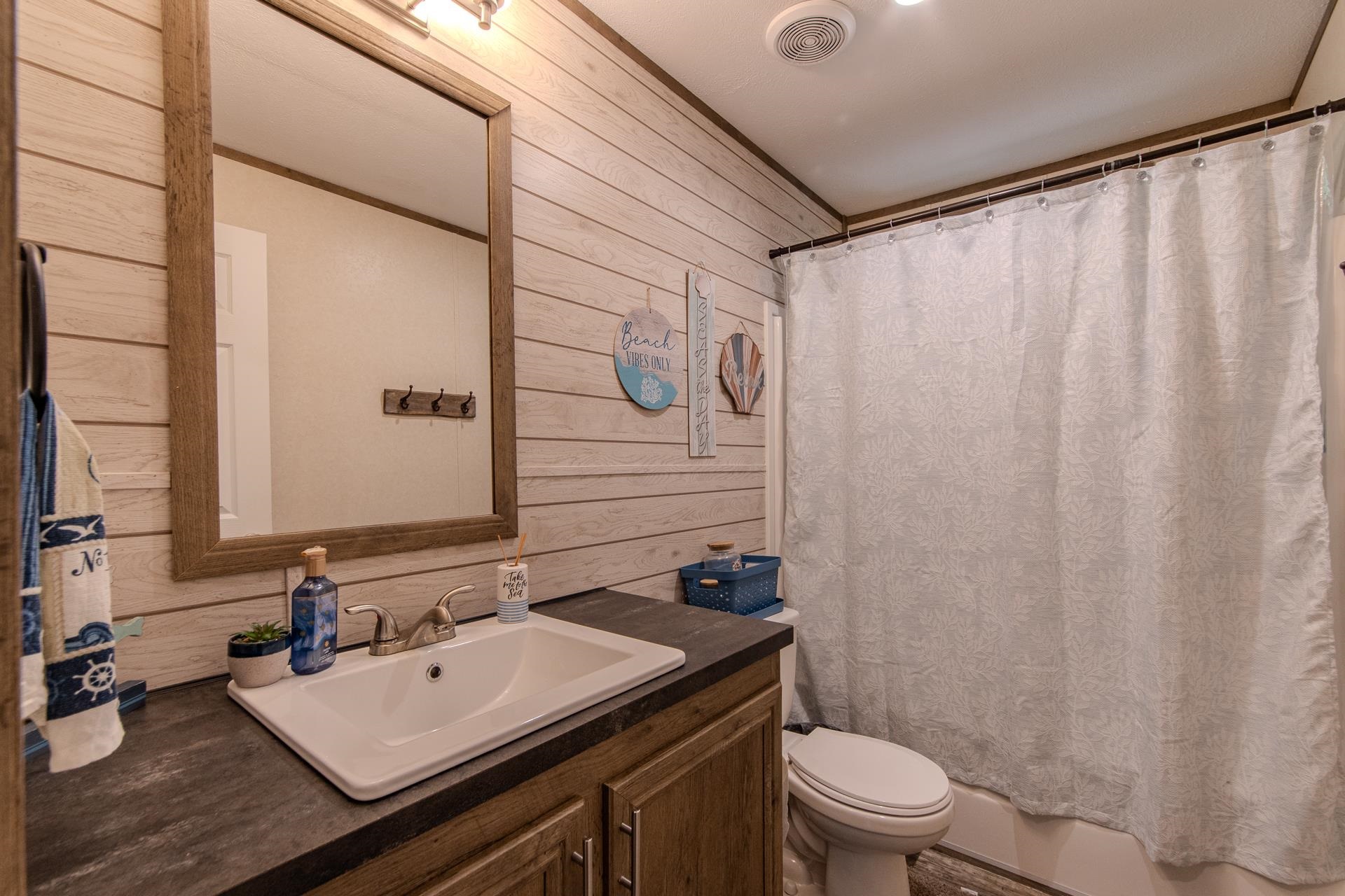 30 Chardonnay Way Counce, TN 38326 - Photo 26 of 37 a bathroom with a sink a toilet and shower curtain