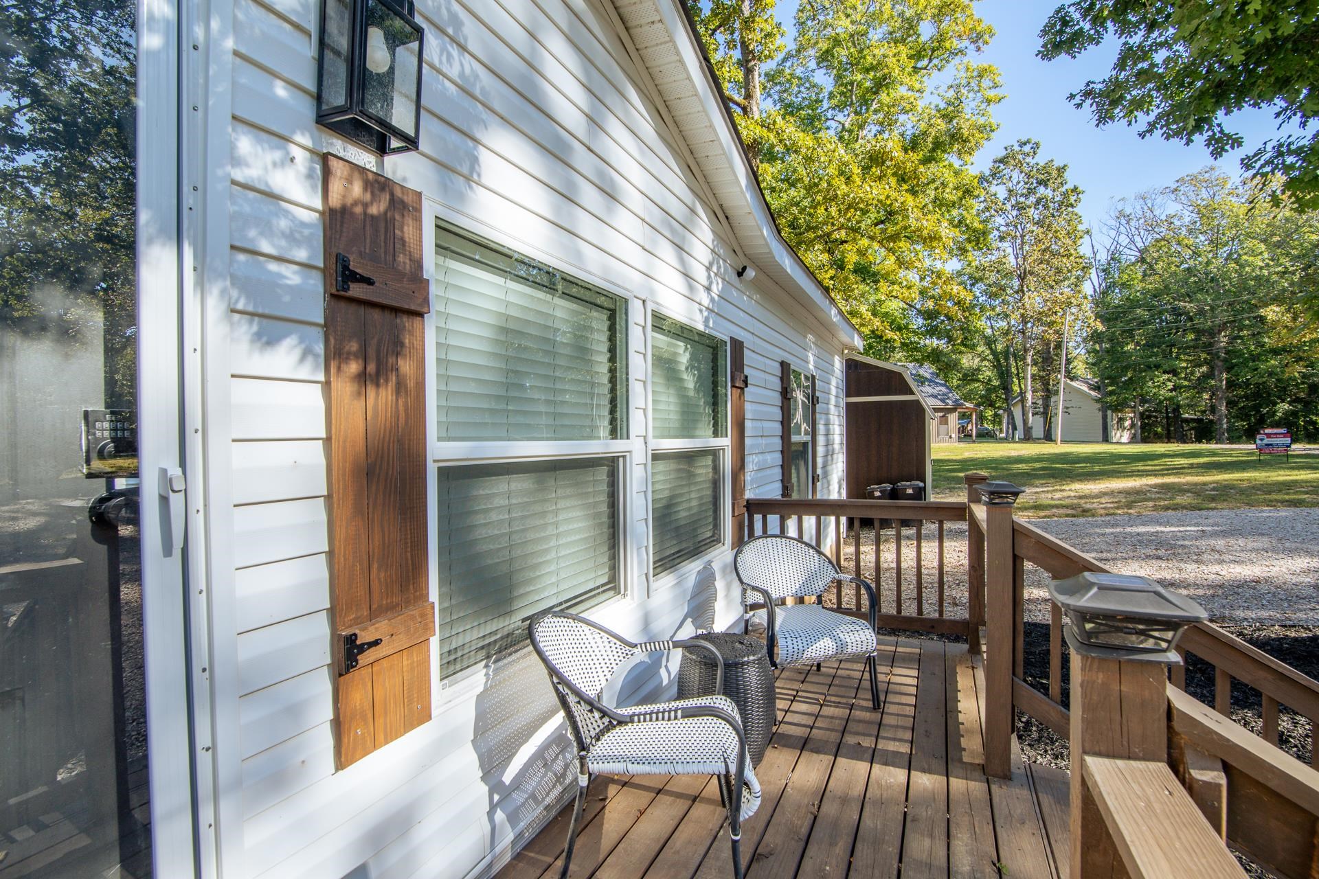 30 Chardonnay Way Counce, TN 38326 - Photo 8 of 37 a view of a patio with table and chairs a barbeque with wooden floor and fence