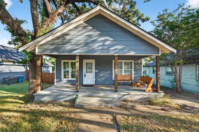 a view of a house with backyard porch and sitting area