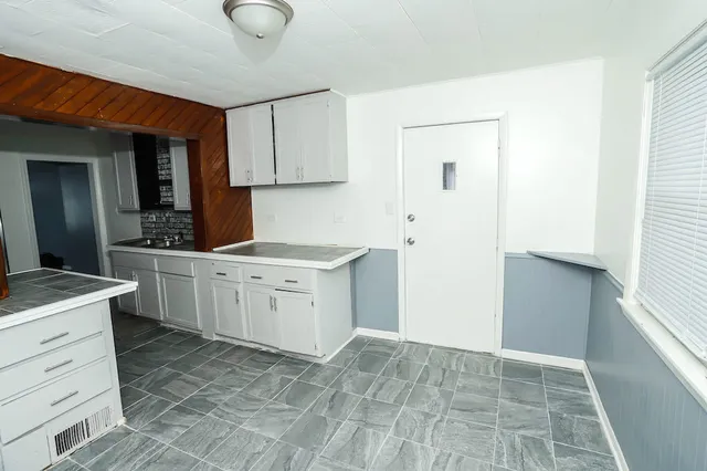 a kitchen with a stove cabinets and a sink
