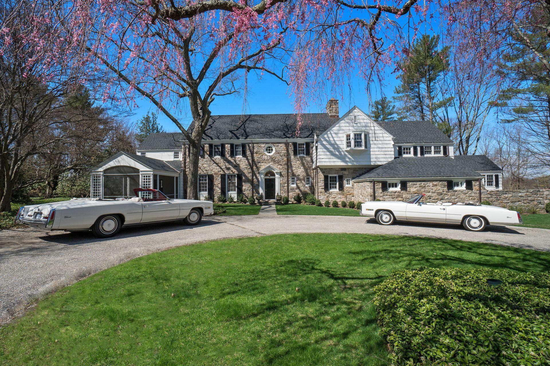 1102 Oenoke Ridge New Canaan, CT 06840 - Photo 1 of 49 a view of a house with a yard and sitting area