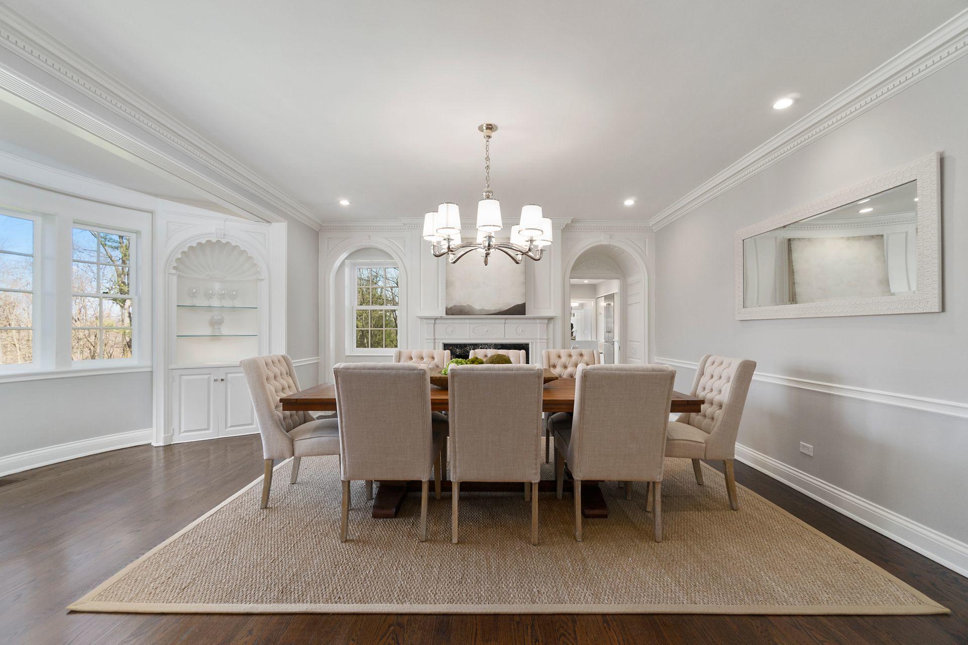 1102 Oenoke Ridge New Canaan, CT 06840 - Photo 11 of 49 a dining room with wooden floor a chandelier a wooden table and chairs