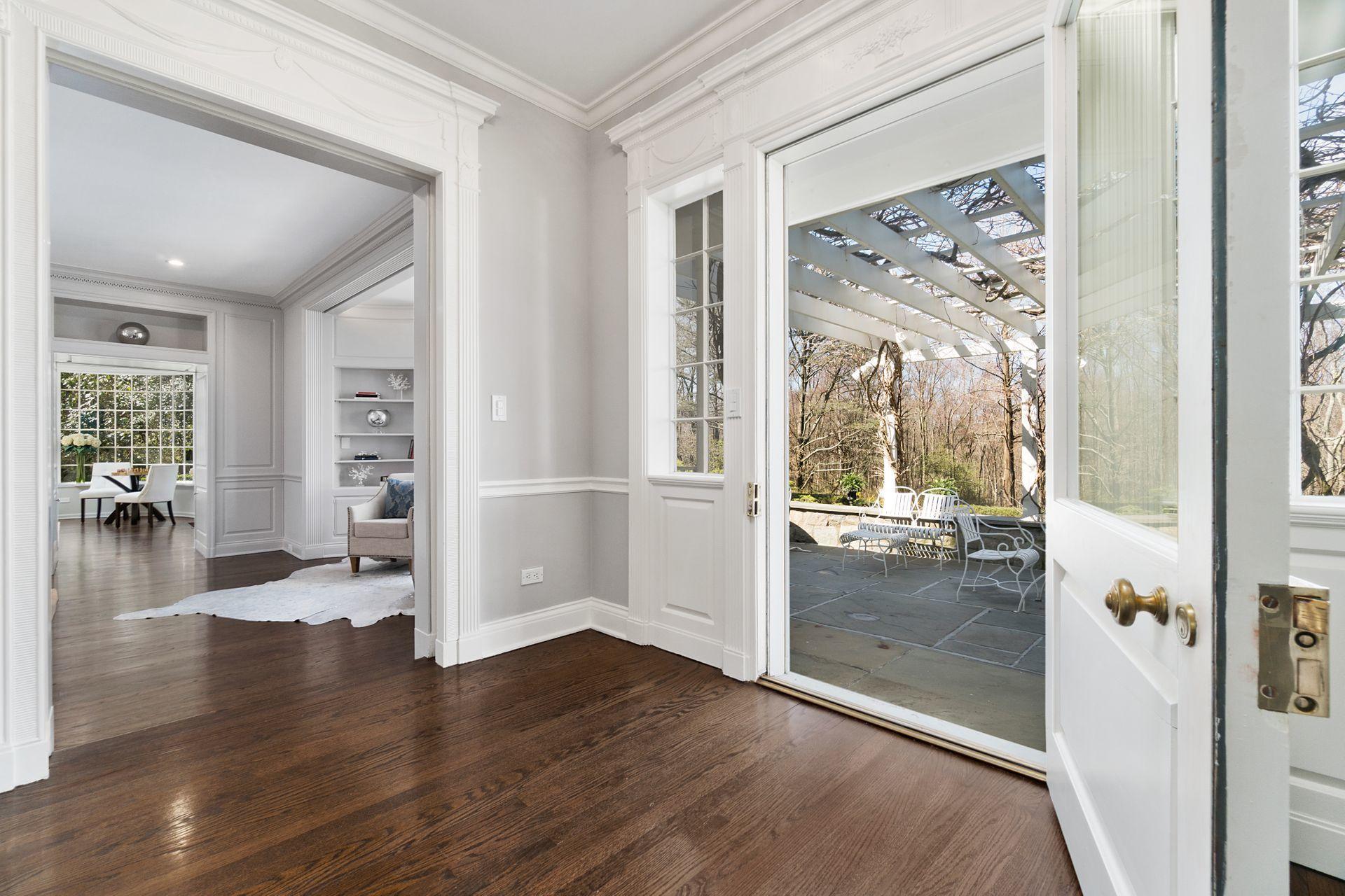 1102 Oenoke Ridge New Canaan, CT 06840 - Photo 15 of 49 a view of a hallway view with wooden floor and windows