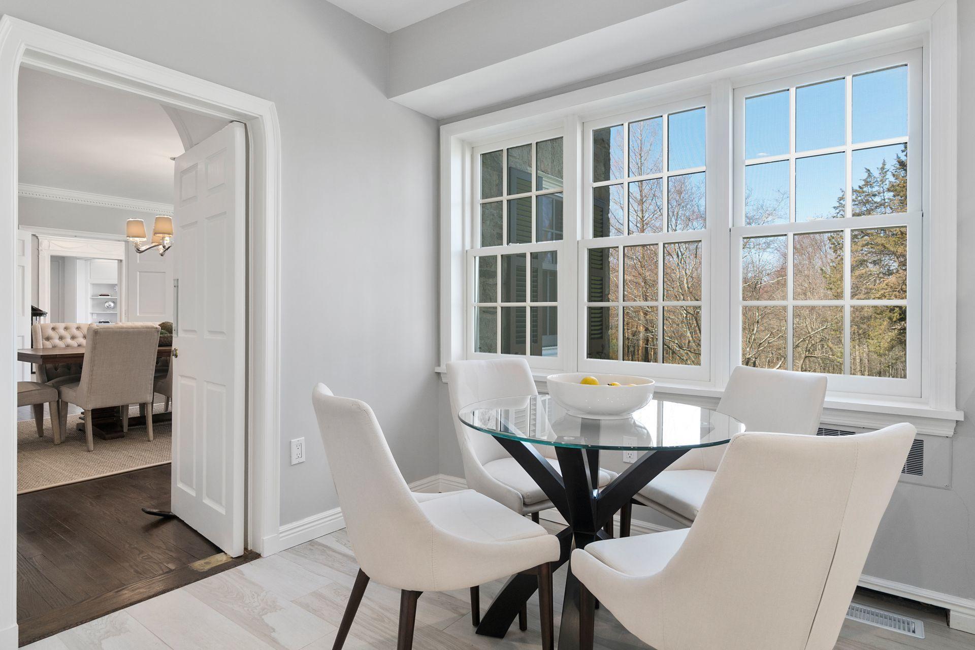 1102 Oenoke Ridge New Canaan, CT 06840 - Photo 18 of 49 a view of a dining room with furniture and windows