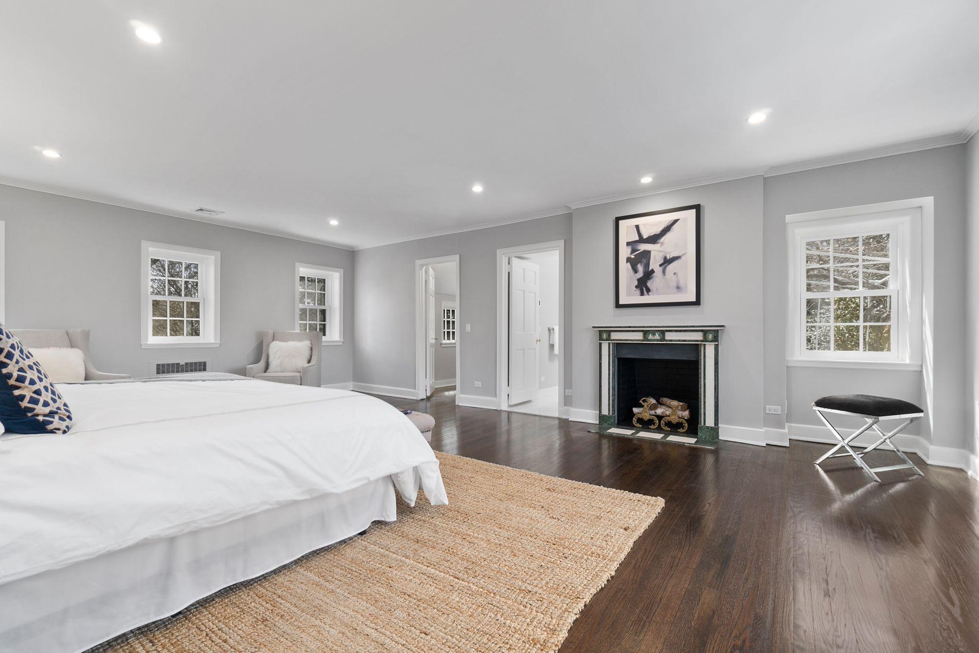 1102 Oenoke Ridge New Canaan, CT 06840 - Photo 25 of 49 a spacious bedroom with a bed and a fireplace