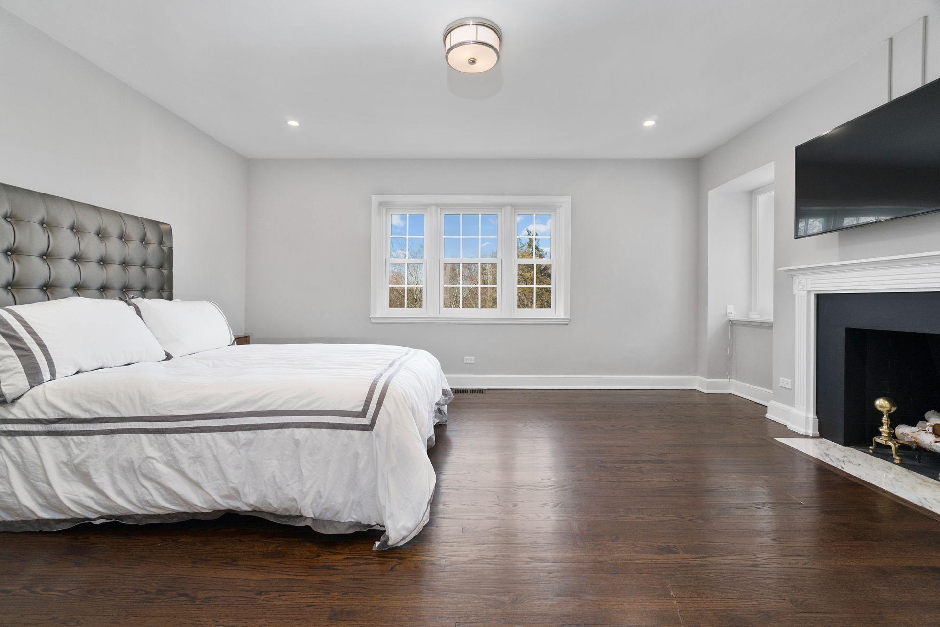 1102 Oenoke Ridge New Canaan, CT 06840 - Photo 30 of 49 a bedroom with a bed and a flat screen tv