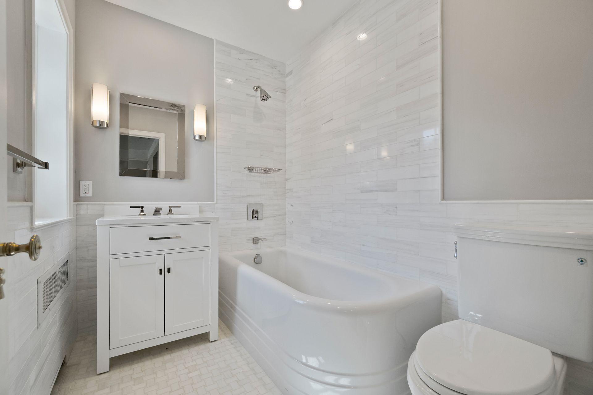 1102 Oenoke Ridge New Canaan, CT 06840 - Photo 31 of 49 a bathroom with a bathtub toilet a sink and mirror