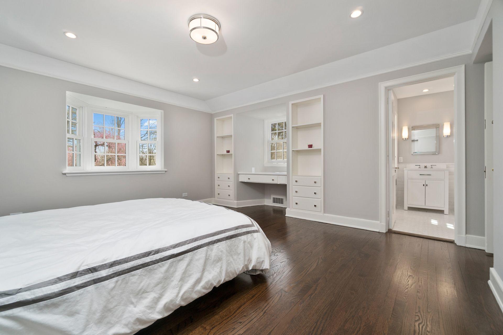 1102 Oenoke Ridge New Canaan, CT 06840 - Photo 33 of 49 a bedroom with a bed and a chandelier