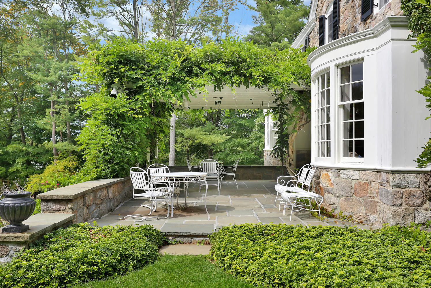 1102 Oenoke Ridge New Canaan, CT 06840 - Photo 39 of 49 a view of backyard of house with outdoor seating and green space