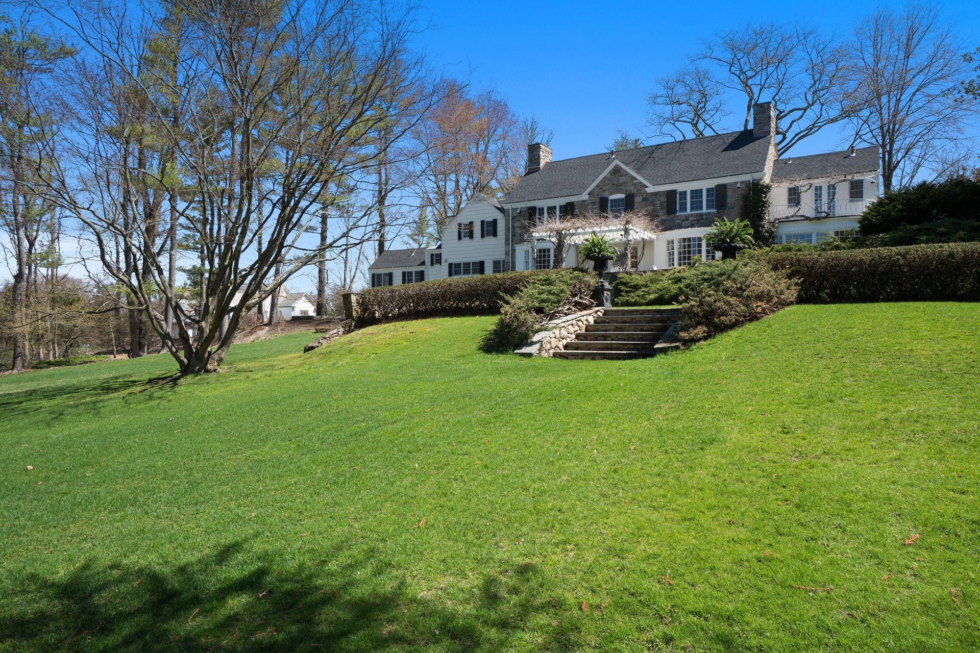 1102 Oenoke Ridge New Canaan, CT 06840 - Photo 41 of 49 a view of a house with garden and a sitting area