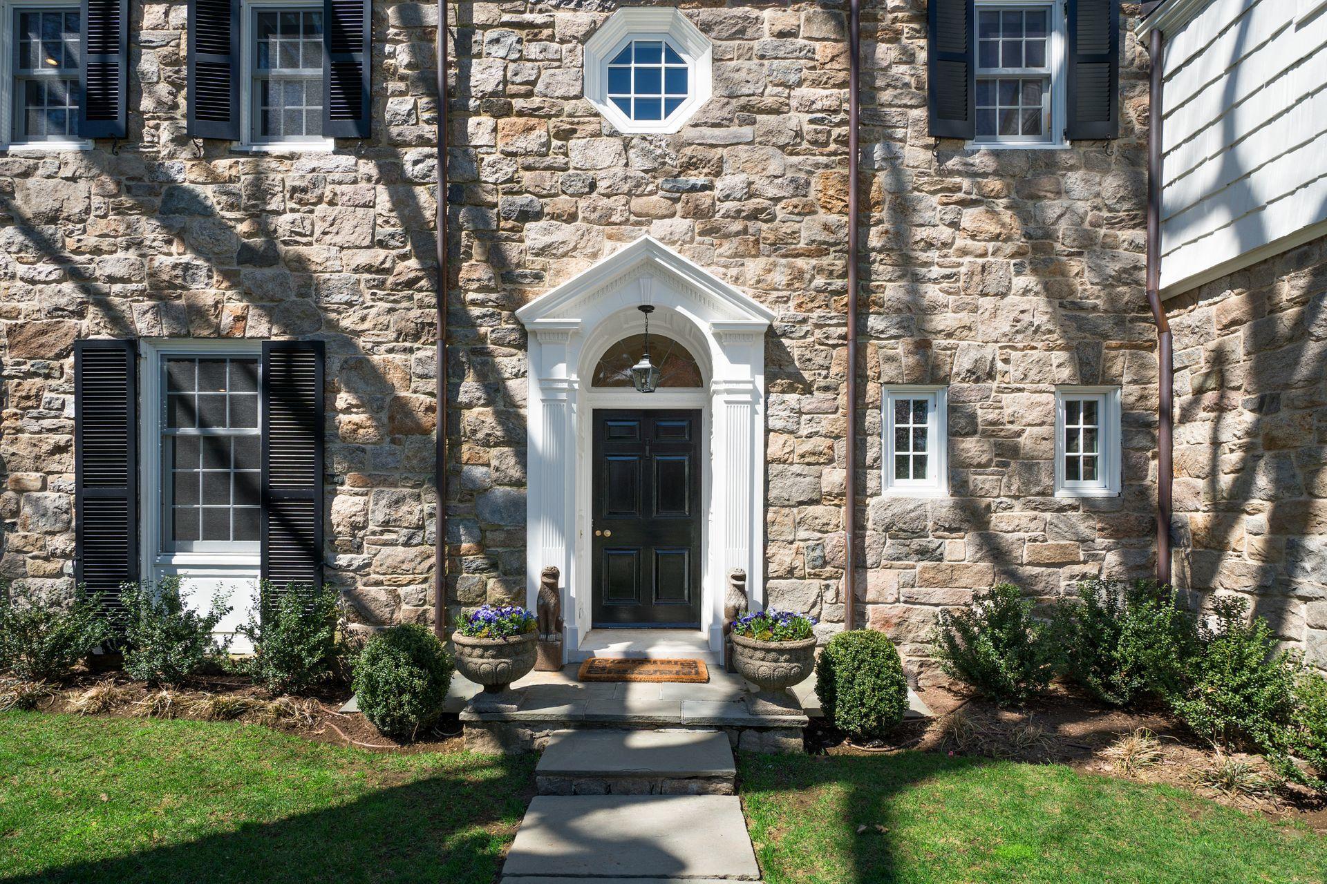 1102 Oenoke Ridge New Canaan, CT 06840 - Photo 42 of 49 a front view of a house with garden