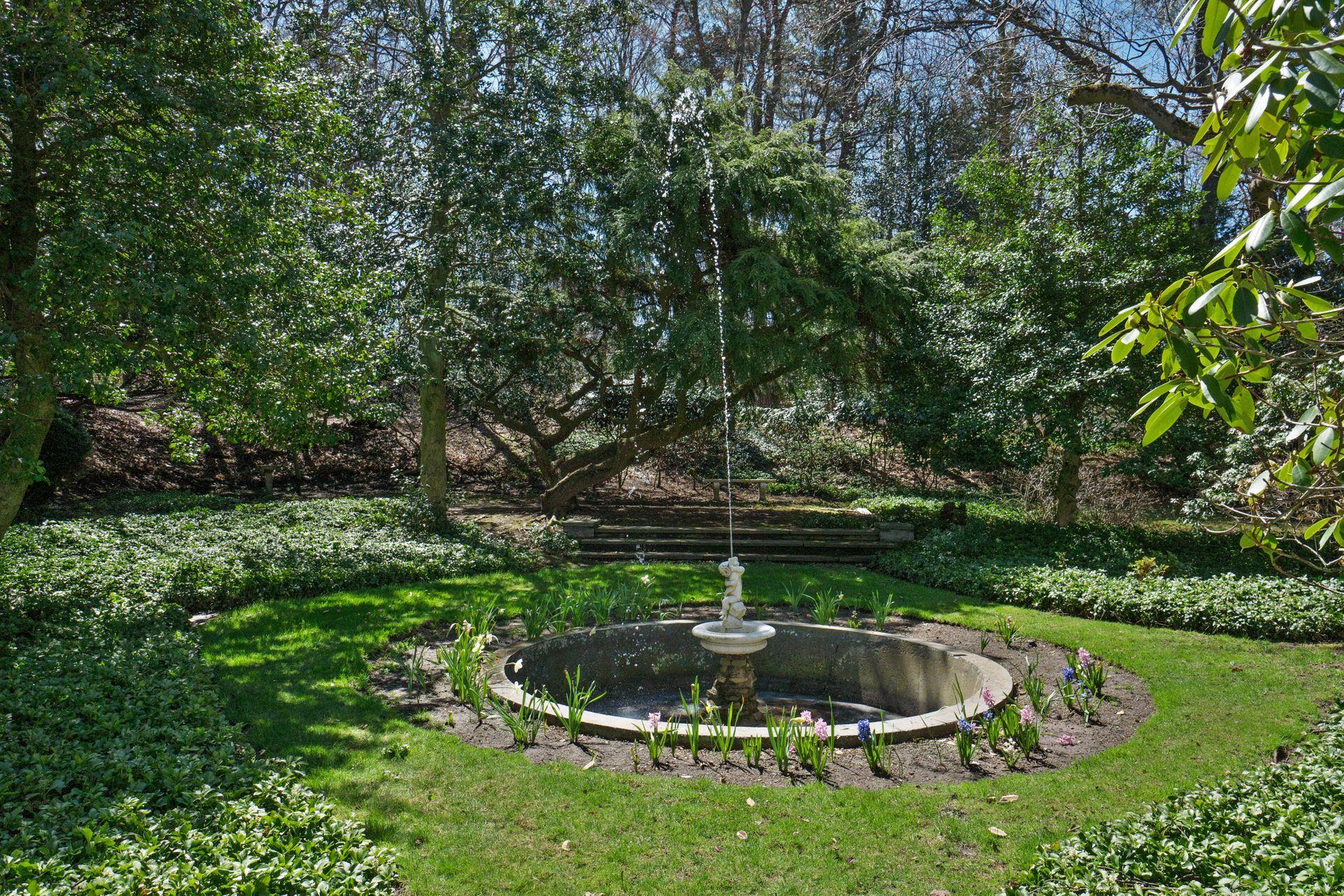 1102 Oenoke Ridge New Canaan, CT 06840 - Photo 43 of 49 a backyard of a house with a yard and outdoor seating