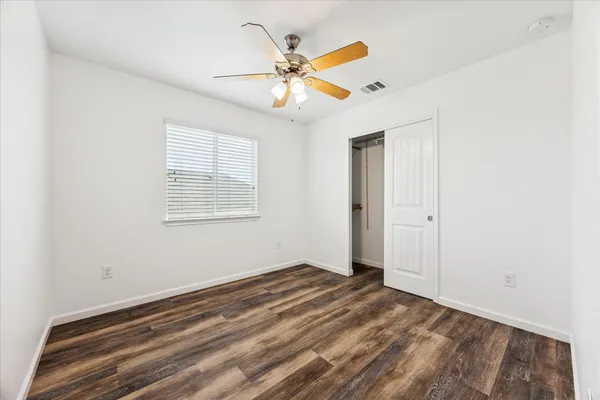a view of a livingroom with a ceiling fan and window
