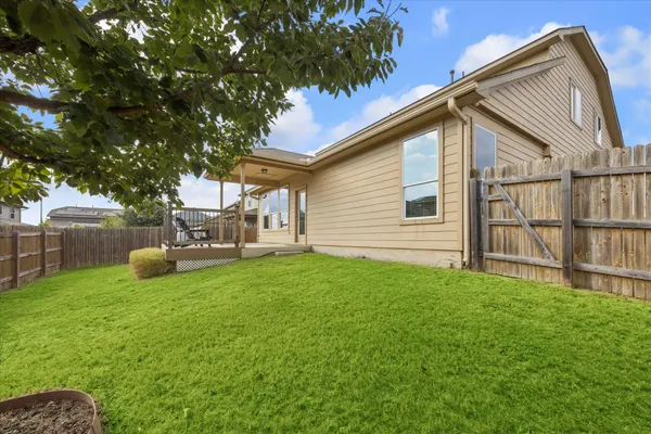 a view of backyard with a garden and deck