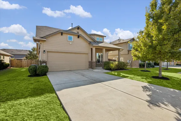 a front view of a house with a yard and garage