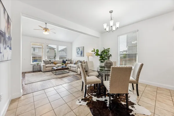 a living room with furniture a chandelier and a chandelier