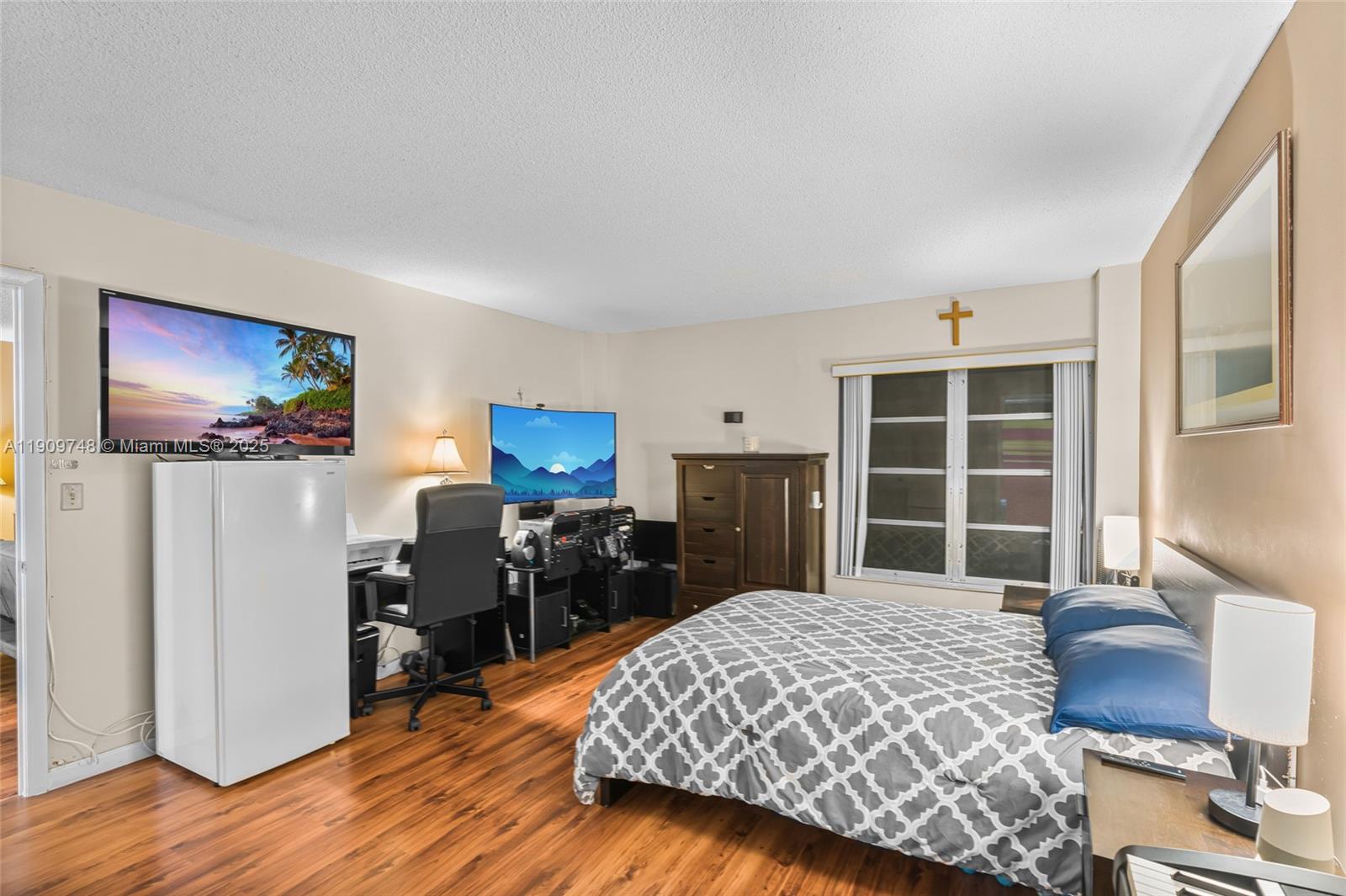 4166 Inverrary Drive, Unit 306 Lauderhill, FL 33319 - Photo 12 of 30 a bedroom with a bed and wooden floor