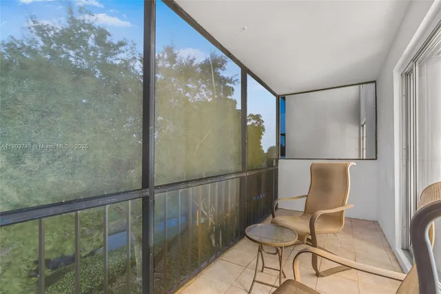 a balcony with table and chairs