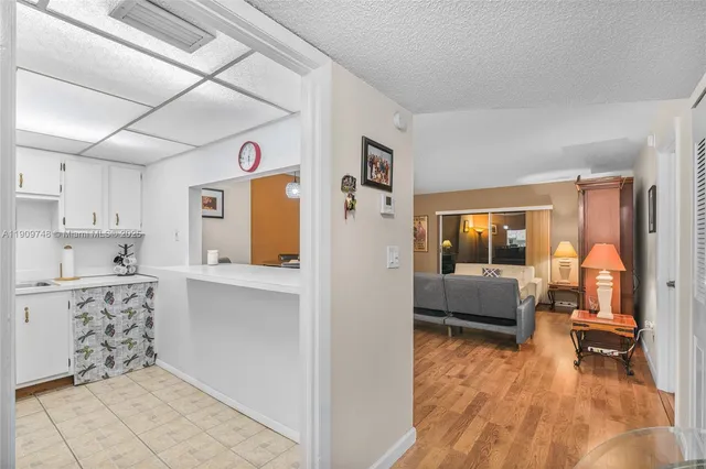 a living room with stainless steel appliances kitchen island granite countertop furniture and a kitchen view