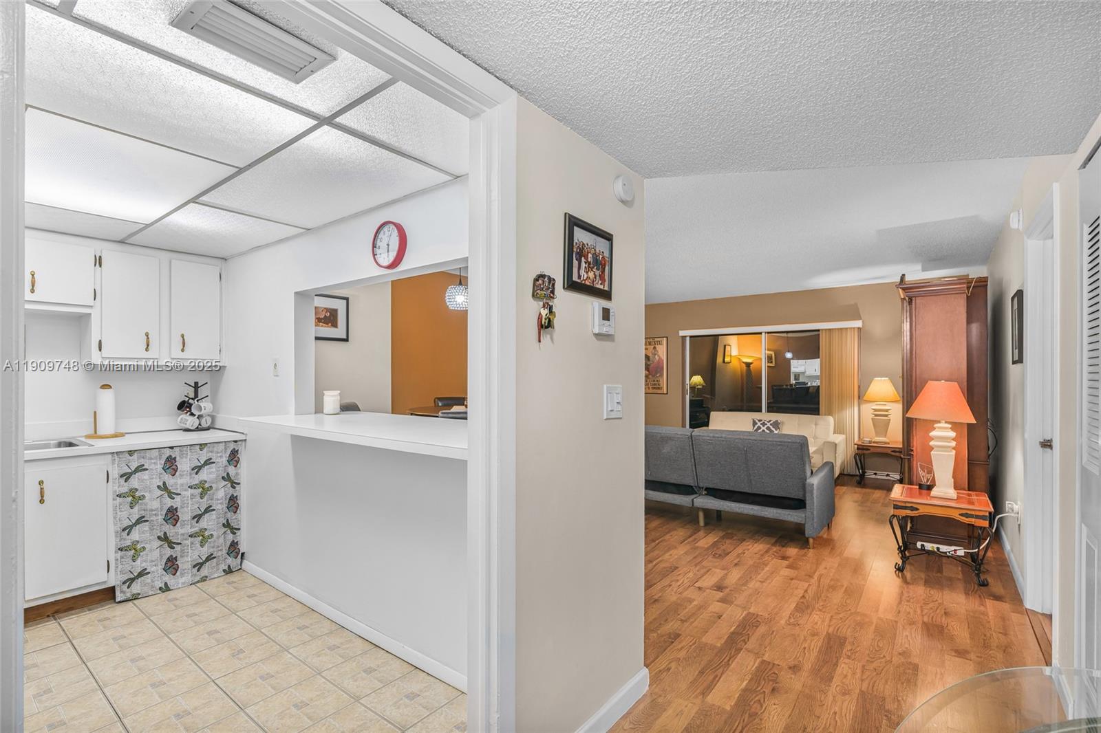 4166 Inverrary Drive, Unit 306 Lauderhill, FL 33319 - Photo 2 of 30 a living room with stainless steel appliances kitchen island granite countertop furniture and a kitchen view