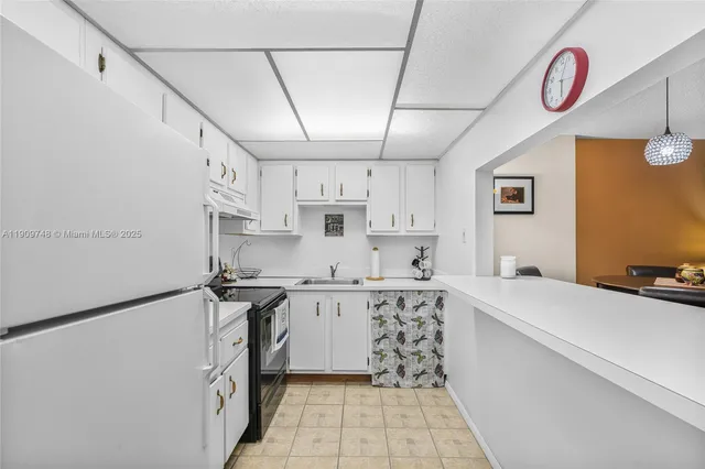 a kitchen with stainless steel appliances a sink stove top oven and cabinets