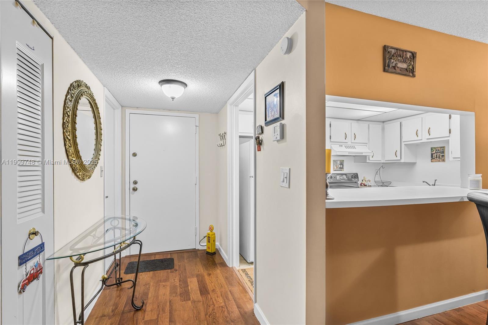 4166 Inverrary Drive, Unit 306 Lauderhill, FL 33319 - Photo 5 of 30 a view of a kitchen with a sink and wooden floor