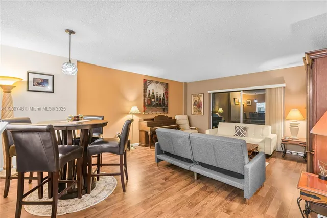 a living room with fireplace furniture and a wooden floor