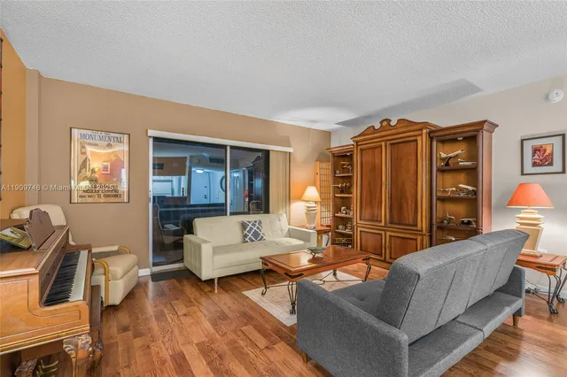 a living room with furniture a wooden floor and a window
