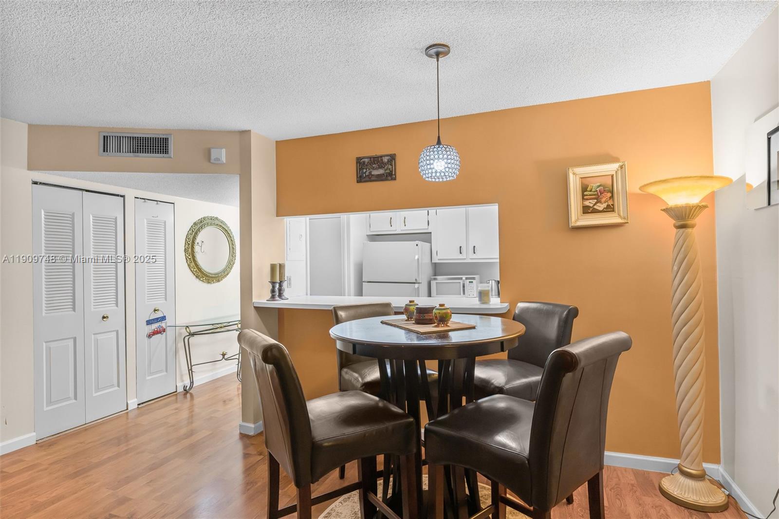 4166 Inverrary Drive, Unit 306 Lauderhill, FL 33319 - Photo 9 of 30 a view of a dining room with furniture and wooden floor