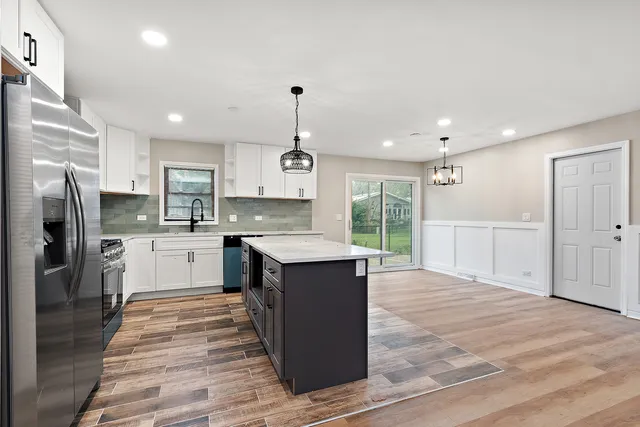 a large kitchen with cabinets and stainless steel appliances