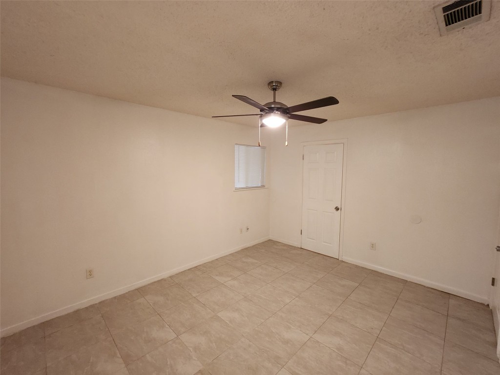 2404 Audubon Place, Unit B Austin, TX 78741 - Photo 16 of 23 an empty room with chandelier fan and windows