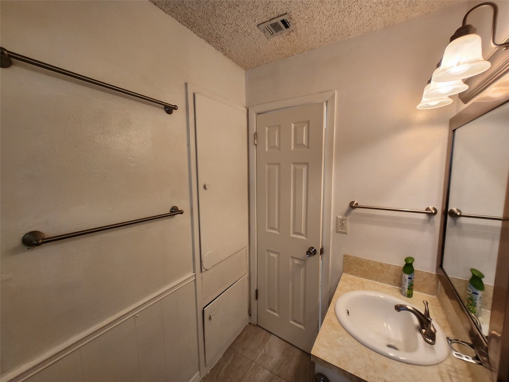 2404 Audubon Place, Unit B Austin, TX 78741 - Photo 21 of 23 a bathroom with a sink and a mirror