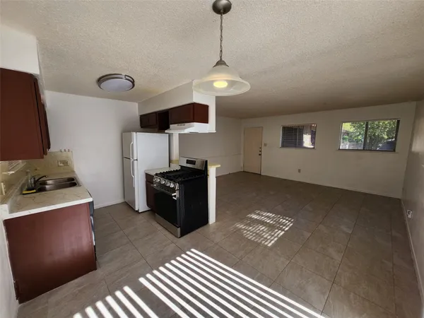 a kitchen with a stove and a refrigerator