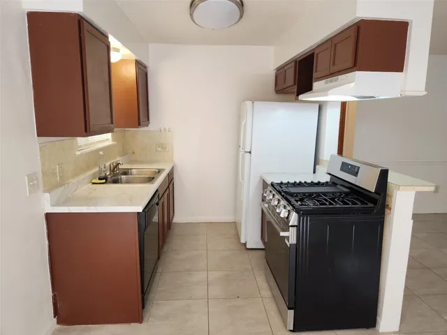 a kitchen with a stove and a sink