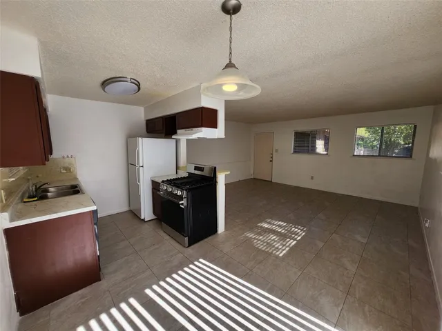 a kitchen with a refrigerator and stove