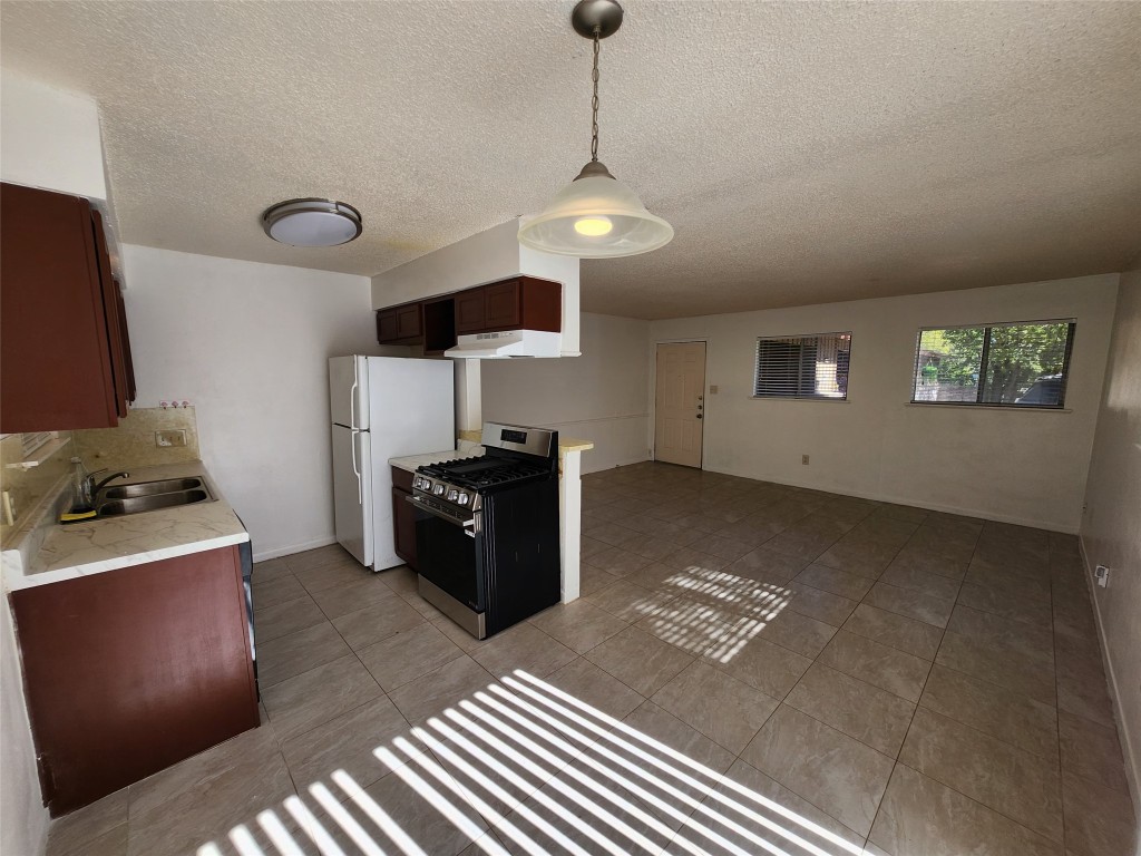 2404 Audubon Place, Unit B Austin, TX 78741 - Photo 9 of 23 a kitchen with a refrigerator and stove