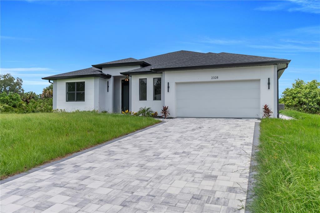 2328 Irondale Road North Port, FL 34287 - Photo 3 of 45 a front view of a house with a garden