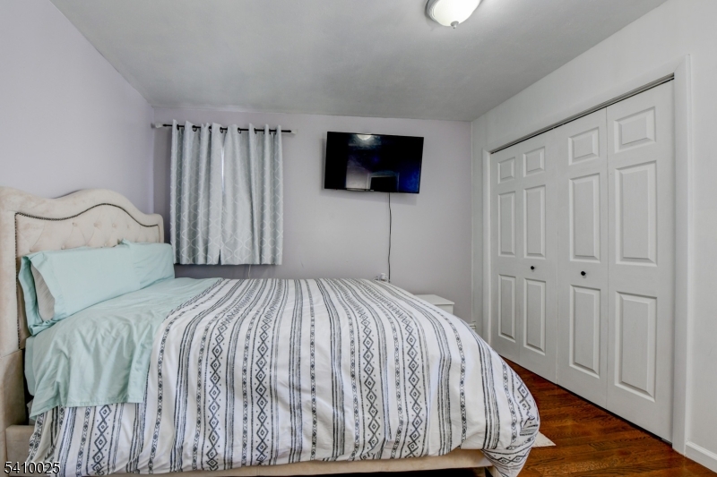 21 Normandy Circle Hopatcong, NJ 07843 - Photo 12 of 22 a bedroom with a bed and a flat screen tv