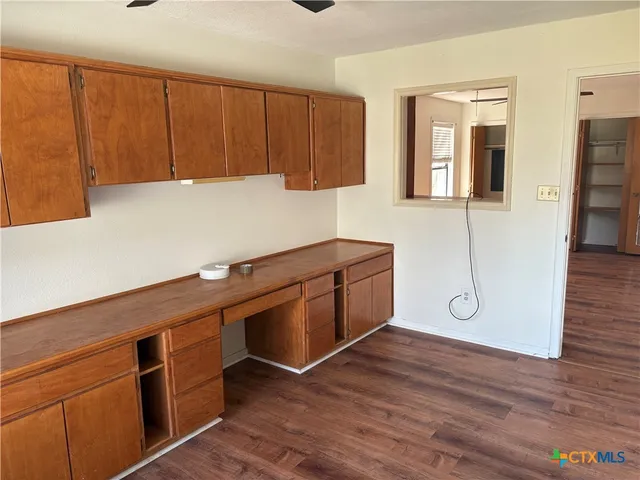 a kitchen with wooden cabinets and sink