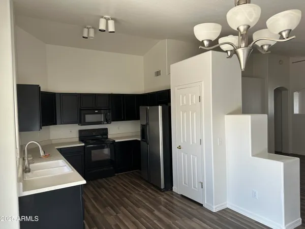 a kitchen with stainless steel appliances a sink stove and refrigerator