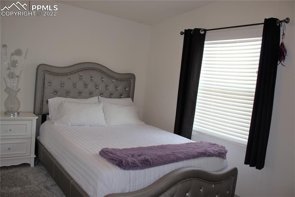 728 Graphite Street Florence, CO 81226 - Photo 14 of 30 a bedroom with a bed and a window